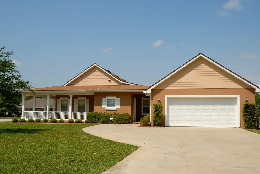 A single-storey house with a covered porch and a two-car garage
